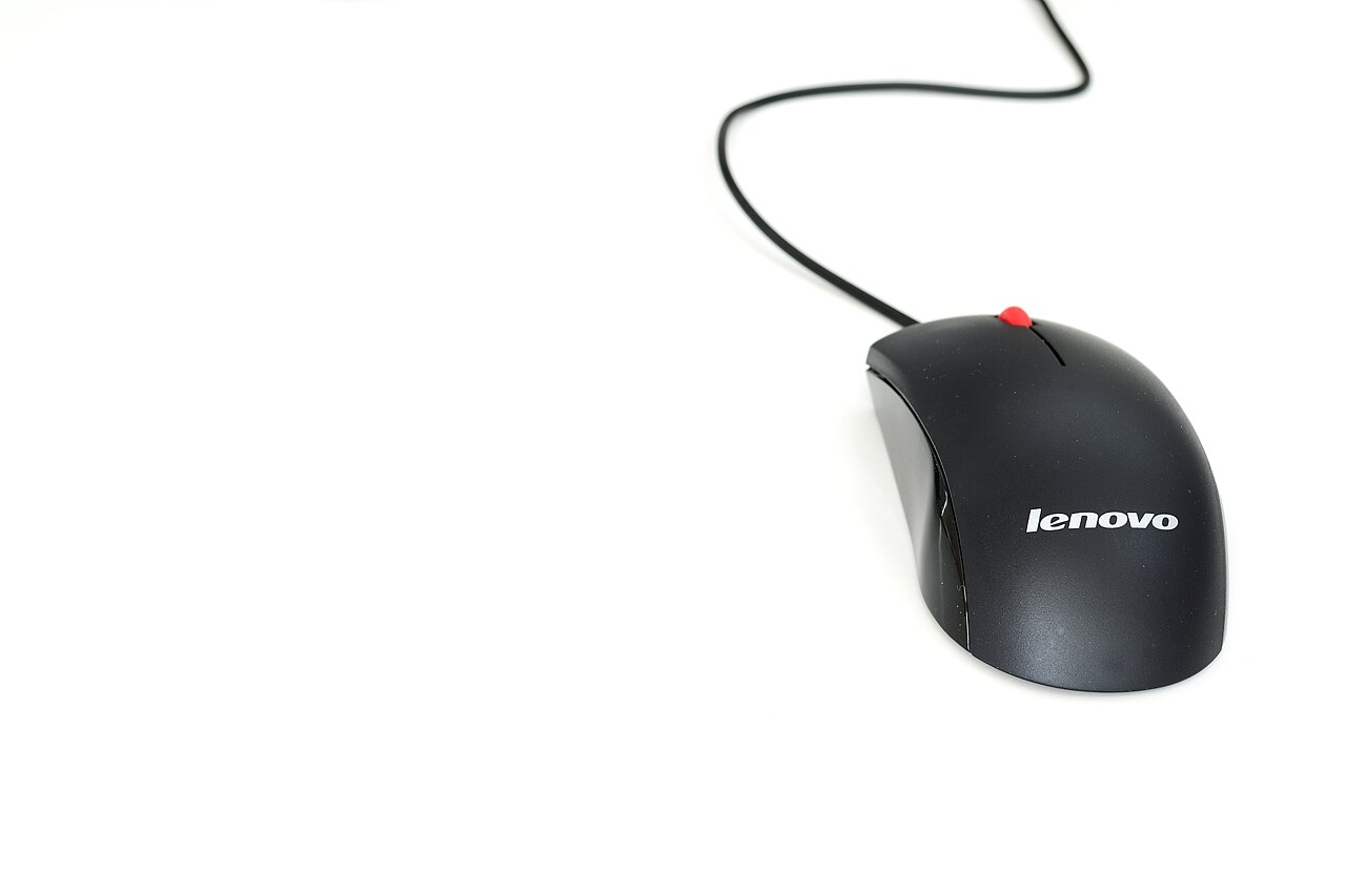 A black wired Lenovo mouse with a red scroll wheel on a white surface.